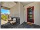 Charming front porch with seating area and welcoming doorway at 7736 Tioga Ridge Ct, Las Vegas, NV 89117