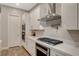 Modern kitchen features stainless steel appliances, white cabinetry, and quartz countertops at 7736 Tioga Ridge Ct, Las Vegas, NV 89117