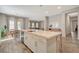 Spacious kitchen island with barstool seating and stainless dishwasher overlooks the backyard at 7736 Tioga Ridge Ct, Las Vegas, NV 89117