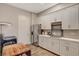 Kitchenette with stainless steel appliances, light countertops, and ample cabinet space at 7736 Tioga Ridge Ct, Las Vegas, NV 89117