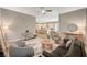Open-concept living room with kitchen view, stylish furnishings, and lots of natural light at 7736 Tioga Ridge Ct, Las Vegas, NV 89117