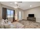 Bright living room featuring stylish wood-look floors, neutral decor and furnishings at 7736 Tioga Ridge Ct, Las Vegas, NV 89117