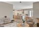 View of living room transitioning into kitchen; light and airy floorplan with island seating at 7736 Tioga Ridge Ct, Las Vegas, NV 89117