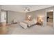 Serene primary bedroom features a ceiling fan, an ensuite, and a walk-in closet at 7736 Tioga Ridge Ct, Las Vegas, NV 89117