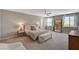 Spacious primary bedroom features a ceiling fan, carpet, and lots of natural light at 7736 Tioga Ridge Ct, Las Vegas, NV 89117