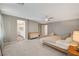 Carpeted primary bedroom featuring an ensuite bathroom and a walk-in closet at 7736 Tioga Ridge Ct, Las Vegas, NV 89117