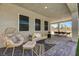 Stylish covered patio with lounge area, dining set, and neutral-toned pavers at 7736 Tioga Ridge Ct, Las Vegas, NV 89117