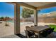Spacious covered patio with seating, desert landscaping, and pool view at 7736 Tioga Ridge Ct, Las Vegas, NV 89117
