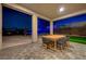 Covered outdoor patio featuring a dining table, stylish chairs, and paved flooring at 7736 Tioga Ridge Ct, Las Vegas, NV 89117
