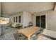 Large covered patio featuring an outdoor dining set, lounge area and pavers at 7736 Tioga Ridge Ct, Las Vegas, NV 89117