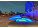 Backyard pool and spa with cool blue lighting set against the desert landscape at 7736 Tioga Ridge Ct, Las Vegas, NV 89117