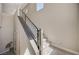 A sleek staircase with modern railings provides access to the upper level at 7736 Tioga Ridge Ct, Las Vegas, NV 89117