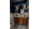 Stylish powder room features a decorative mirror, wood vanity, and unique patterned tile floor at 7988 Pinnacle Peak Ave, Las Vegas, NV 89113