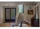 Light filled foyer with staircase and decorative glass block window at 7988 Pinnacle Peak Ave, Las Vegas, NV 89113