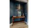 Hallway nook with console table, modern light fixture, and artwork at 7988 Pinnacle Peak Ave, Las Vegas, NV 89113