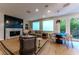 Bright living room includes a dining area and view of outdoor greenery through the glass doors at 7988 Pinnacle Peak Ave, Las Vegas, NV 89113