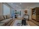 Open-concept living room with light wood floors, modern decor and a view into the kitchen at 7988 Pinnacle Peak Ave, Las Vegas, NV 89113