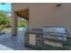 Outdoor kitchen with built-in grill, countertop, and storage, perfect for outdoor entertaining at 7988 Pinnacle Peak Ave, Las Vegas, NV 89113