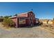 A charming red barn with white trim and a weather vane at 861 Mcmurray Dr, Pahrump, NV 89060