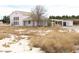 Quaint two-story home featuring carport, shed, and desert landscaping at 861 Mcmurray Dr, Pahrump, NV 89060