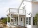 Charming two-story white home with a lattice-covered balcony at 861 Mcmurray Dr, Pahrump, NV 89060