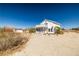 White two-story home exterior, with a balcony, on a clear blue-sky day at 861 Mcmurray Dr, Pahrump, NV 89060