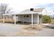 The exterior of a carport located next to a white home with a matching white roof at 861 Mcmurray Dr, Pahrump, NV 89060