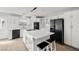 Modern kitchen featuring white cabinets, a spacious island, and black appliances at 861 Mcmurray Dr, Pahrump, NV 89060