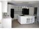 Open kitchen featuring white cabinets and a large island with seating at 861 Mcmurray Dr, Pahrump, NV 89060