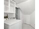 Bright laundry room with a white washer and dryer and storage space at 861 Mcmurray Dr, Pahrump, NV 89060