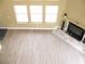 View of the living room featuring a fireplace, light filled room, and wood floors at 861 Mcmurray Dr, Pahrump, NV 89060