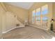 Bright living room featuring expansive windows, high ceilings, and staircase at 861 Mcmurray Dr, Pahrump, NV 89060