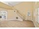 Bright living room showcasing wood floors, staircase, and arched entryway leading into the kitchen at 861 Mcmurray Dr, Pahrump, NV 89060