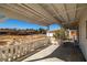 Covered patio and outdoor area with a painted white railing, and dry landscape at 861 Mcmurray Dr, Pahrump, NV 89060