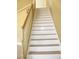 Close up view of carpeted staircase with white risers and oak railings at 861 Mcmurray Dr, Pahrump, NV 89060