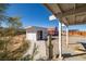 View of an outbuilding and white house from the yard at 861 Mcmurray Dr, Pahrump, NV 89060