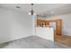 Bright dining area with wood-style floors adjacent to kitchen with light wood cabinetry and breakfast bar at 8789 Villa Alex Ave, Las Vegas, NV 89147