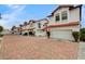 Street view of well-maintained homes with red tile roofs and paved driveways at 8789 Villa Alex Ave, Las Vegas, NV 89147