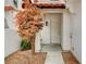 Inviting front entrance with a decorative tree and pathway leading to the door at 8789 Villa Alex Ave, Las Vegas, NV 89147