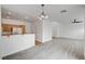 Open-concept living space with hardwood floors and a view into the kitchen area at 8789 Villa Alex Ave, Las Vegas, NV 89147