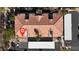 Aerial view of the home with tile roofing, a parking area and mature landscaping at 950 Seven Hills Dr # 2418, Henderson, NV 89052
