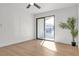 Sunlit bedroom featuring modern wood flooring and sliding glass doors to a balcony at 950 Seven Hills Dr # 2418, Henderson, NV 89052