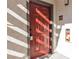 Inviting front door with prominent numbering and a convenient fire extinguisher box at 950 Seven Hills Dr # 2418, Henderson, NV 89052