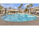 Community pool with marked depths and lounge chairs under shaded pergolas at 950 Seven Hills Dr # 2418, Henderson, NV 89052