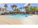 Community pool area with palm trees, pergola covered lounge areas and a pebble tec pool at 950 Seven Hills Dr # 2418, Henderson, NV 89052