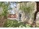 Low-maintenance backyard with artificial grass, brick walls, and mature landscaping at 9617 Sharp Horn Ct, Las Vegas, NV 89149