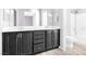 Bright bathroom with dual sinks, dark cabinetry, and a separate shower and tub at 9617 Sharp Horn Ct, Las Vegas, NV 89149