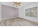 Bright bedroom features wood-look floors, ceiling fan and large window at 9617 Sharp Horn Ct, Las Vegas, NV 89149