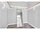 Walk-in closet features hanging racks and mirror at 9617 Sharp Horn Ct, Las Vegas, NV 89149