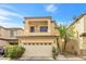 Charming two-story home with a tan facade, a balcony and a two-car garage and well-maintained landscaping at 9617 Sharp Horn Ct, Las Vegas, NV 89149